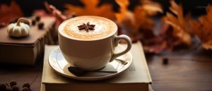 Autumn theme, pumpkin spice latte on a hardcover book